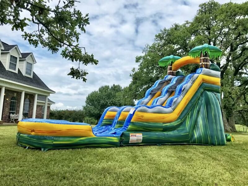Tropical inflatable water slide set up on a lawn
